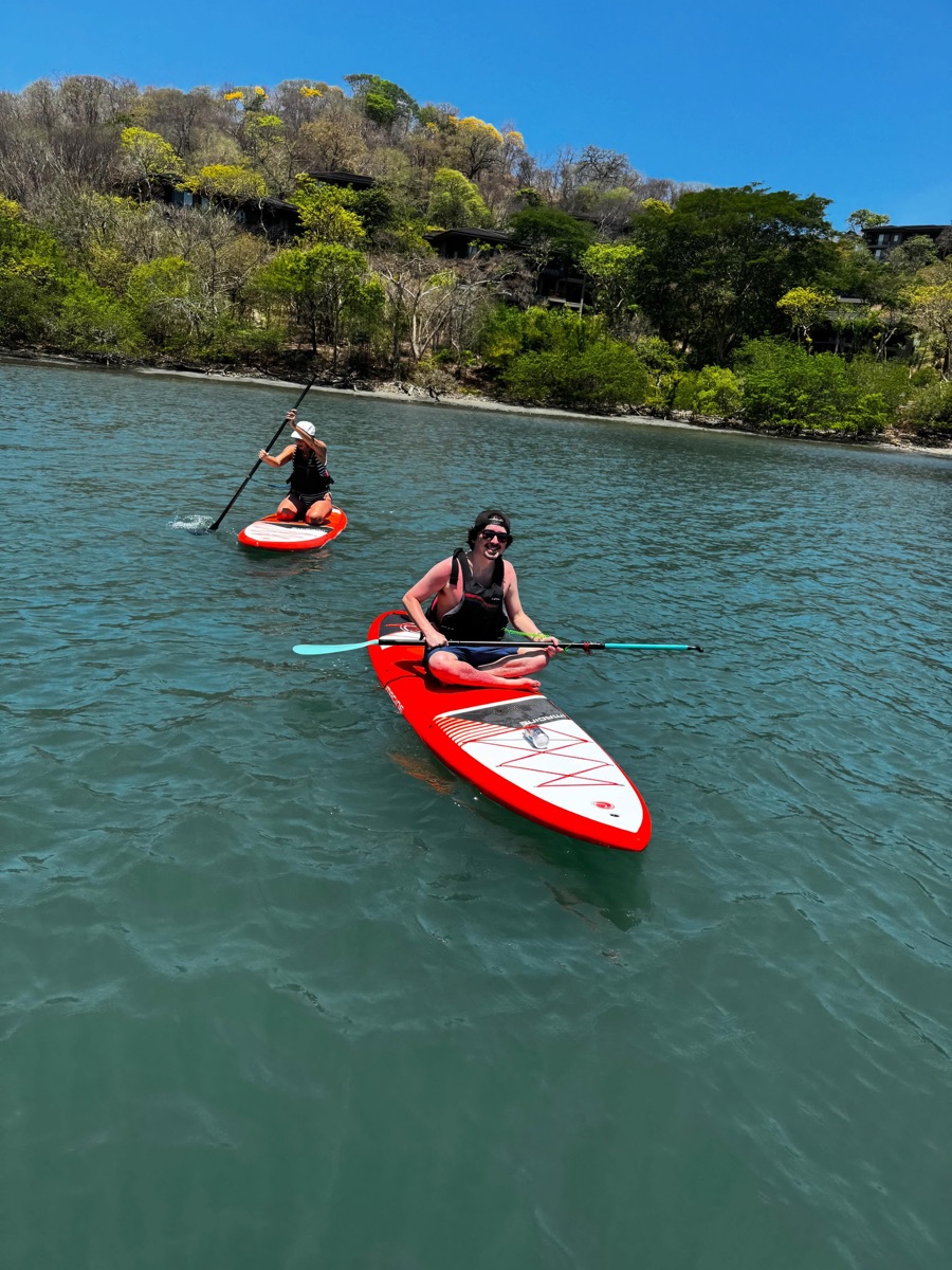 Zach paddleboarding on turquoise water